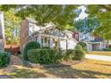 Beautifully landscaped two-story home with a well-manicured lawn in a suburban neighborhood at 1535 Justine Se Way, Mableton, GA 30126