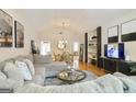 Spacious living room open to dining area, featuring hardwood floors and modern furnishings at 3417 Double Eagle Dr # Bldg 31, Marietta, GA 30008