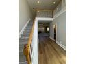 Welcoming entryway with hardwood floors, staircase, and views into the living space at 135 Danube Trl, Stockbridge, GA 30281