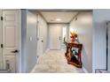 Inviting foyer with tile flooring, light gray walls, and a decorative console table with an accent mirror at 2582 Rosecommons Dr, Hampton, GA 30228