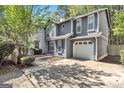 Attractive two-story home with a garage, showcasing its curb appeal and architectural details at 2998 Kenville Ln, Decatur, GA 30034