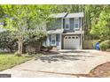 Lovely home with an attached garage, complemented by a well-manicured lawn and inviting driveway at 2998 Kenville Ln, Decatur, GA 30034