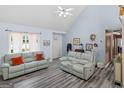 Spacious living room with two couches, luxury vinyl plank flooring, vaulted ceilings and bright natural light at 2040 Elm Grove Ln, Hampton, GA 30228