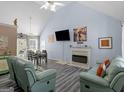 Bright living room with vaulted ceilings, fireplace, television, and comfortable seating with luxury vinyl plank floors at 2040 Elm Grove Ln, Hampton, GA 30228