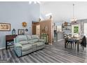 Inviting living room with gray luxury vinyl plank floors, comfortable seating, and decor at 2040 Elm Grove Ln, Hampton, GA 30228