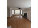 Open living room with hardwood floors, large bay window and a cozy fireplace at 1232 Memorial Se Dr, Atlanta, GA 30316