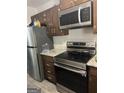 Bright kitchen with stainless steel appliances and granite countertops at 1331 Woodstone Trce, Morrow, GA 30260