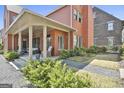 Lovely brick home with covered porch, featuring lush landscaping and a tranquil outdoor space at 175 Central Ave, Fayetteville, GA 30214
