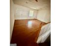 Spacious living area showcasing hardwood floors and a staircase at 5730 Koweta Rd, South Fulton, GA 30349