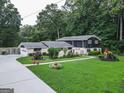 Charming home exterior with lush landscaping, mature trees and a inviting lawn at 4213 Janice Drive, Atlanta, GA 30337