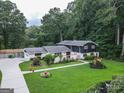 Beautiful exterior featuring a well-manicured lawn and unique landscaping at 4213 Janice Drive, Atlanta, GA 30337
