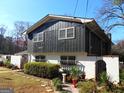 A view of the home, displaying a unique design with a combination of textures and a neatly kept garden at 4213 Janice Drive, Atlanta, GA 30337