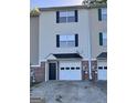 Close up on a townhouse, highlighting the brick accents and garage door at 33 Corinth Rd, Cartersville, GA 30121