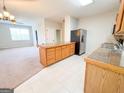 Bright kitchen with island, tile floors, and stainless steel refrigerator at 33 Corinth Rd, Cartersville, GA 30121