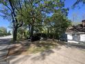 Street view with a partial of the front of the house under the shade of a tree at 4582 Hendrix Dr, Forest Park, GA 30297