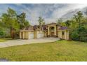 Gorgeous two-story home featuring a three-car garage and well-manicured lawn at 345 Phillips Dr, Fayetteville, GA 30214
