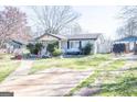 Charming single-story home with front yard and driveway on a sunny day at 30 Millwood Dr, Covington, GA 30016