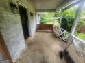 Charming porch with a seating area and a side view of surrounding greenery at 30 Millwood Dr, Covington, GA 30016