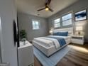 Inviting bedroom with large windows, neutral tones, hardwood floors, and a cozy, bright ambiance at 1745 Rockbridge Nw Rd, Conyers, GA 30012