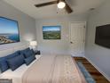 Serene bedroom featuring a large bed, hardwood floors, ambient lighting, and modern decor at 1745 Rockbridge Nw Rd, Conyers, GA 30012