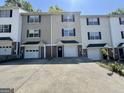 A row of two-story townhomes featuring attached garages, driveways, and neutral exteriors at 23 Corinth Rd, Cartersville, GA 30121