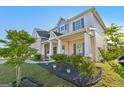 Beautiful home showcasing manicured landscaping and a covered front porch, creating an inviting curb appeal at 255 Orchid Dr, Mcdonough, GA 30252