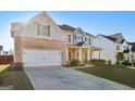 A well-maintained home with a spacious driveway, two car garage, and traditional architectural details at 255 Orchid Dr, Mcdonough, GA 30252