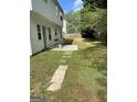 Partially fenced backyard with a small patio area, perfect for grilling and entertaining at 390 Hulan Way, Lawrenceville, GA 30044