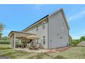 Large backyard featuring a covered patio with seating and a dining area at 185 Discovery Lake Dr, Fayetteville, GA 30215