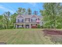 Attractive home with a spacious front yard and mature trees at 185 Discovery Lake Dr, Fayetteville, GA 30215