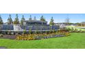 Beautiful Champions Run community entrance with decorative stone and colorful flowerbeds at 1626 Palladian Way # 118, Lithonia, GA 30058