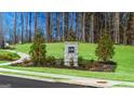 Stone pillar signage surrounded by landscaping at Champions Run at 1626 Palladian Way # 118, Lithonia, GA 30058