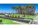 Scenic street view featuring lush greenery, trees, and community signage near Seabiscuit Rd at 1626 Palladian Way # 118, Lithonia, GA 30058