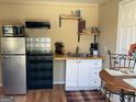 Efficient kitchenette featuring retro-style refrigerator, sink and countertops at 6052 Pine St, Austell, GA 30106
