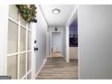 Bright hallway with wood-look flooring, leading to multiple rooms and featuring fresh paint at 98 Almon Church Rd, Covington, GA 30014