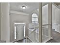 Welcoming foyer featuring a staircase, white trim, and a window for natural light at 28 Willow Ridge Dr, Hampton, GA 30228