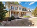 Charming home with stone accents and a welcoming front porch with fresh landscaping and brick walkway at 3065 Willow Park Dr, Dacula, GA 30019