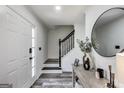 Inviting foyer with modern decor, staircase, and wood-look flooring at 200 Tait Rd, Stockbridge, GA 30281