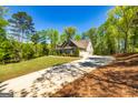 An exterior view of the home and driveway surrounded by trees at 410 Wicklow St, Tyrone, GA 30290