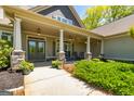 A relaxing porch view with stone supports and rocking chairs at 410 Wicklow St, Tyrone, GA 30290