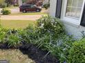 Beautiful landscaping with flowers and mulch near home's brick facade at 411 Sherrels Frd, Peachtree City, GA 30269