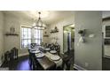 Inviting dining room featuring a wooden table, dark wood flooring, and stylish chandelier at 5133 Woodmond Dr, Villa Rica, GA 30180