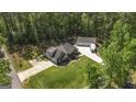 Stunning aerial view of a well-maintained home with a lush green lawn and mature trees at 5133 Woodmond Dr, Villa Rica, GA 30180