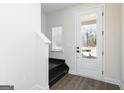 Bright entryway with hardwood floors, stairs, and a view through the front door at 383 Cantrell Drive, Dallas, GA 30157