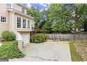 Spacious backyard with a private driveway, deck, and access to lower-level garage at 3328 Sulky Se Cir, Marietta, GA 30067