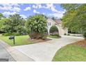 Beautiful home exterior with well-manicured lawn, mature trees, and a circular driveway at 3328 Sulky Se Cir, Marietta, GA 30067