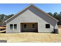 A view of the back of the home featuring an open covered patio with a view of the treeline in the background at 435 Cantrell Drive, Dallas, GA 30157