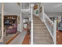 Grand foyer featuring a staircase, hardwood floors, and a view into other living spaces at 11 Frances Turn, Sharpsburg, GA 30277