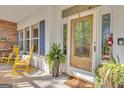Inviting front porch area with rocking chairs and decorative plants that add character to the entrance at 11 Frances Turn, Sharpsburg, GA 30277