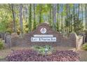 Welcoming community entrance sign to Le Paradis, featuring lush foliage at 11 Frances Turn, Sharpsburg, GA 30277